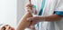 Medical professional administering nerve block injection into patient’s arm