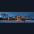 Calgary home with permanent roofline lighting at winter dusk
