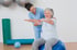 A chiropractor helping a senior woman with exercises.
