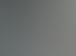 Ein Arbeiter schweißt an einer großen Metallkonstruktion in einer Werkstatt.