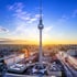 Berliner Fernsehturm bei Sonnenuntergang über der Stadtlandschaft mit dem Roten Rathaus und dem Alexanderplatz.