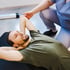 Man with therapist support, illustrating pelvic floor therapy care.