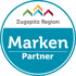 Zugsitz Region Marken Partner Logo mit bunten Bergsymbolen und Text.