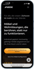 Smartphone zeigt die Muecke-Website mit Text über Möbel und Wohnlösungen, sowie zwei Buttons.