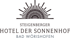 Logo des Steigenberger Hotel Der Sonnenhof Bad Wörishofen mit stilisiertem Sonnenmotiv.