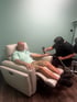 Chiropractor treating a patient with a therapy device.