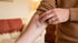 A person points to a large purple and blue bruise on their inner forearm.