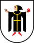 Wappen mit Mönch in schwarzer Kutte, goldener Stola, rotem Buch und zeigendem Finger auf weißem Schild.