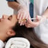 A woman receives a Botox injection in her forehead.
