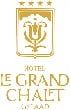 Goldenes Logo mit Wappen, Initial „U“, fünf Sternen und Text: „HOTEL LE GRAND CHALET GSTAAD“.