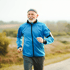 A healthy older man running outdoors.