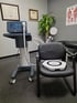 Chiropractic clinic equipment with treatment chair and anatomy charts