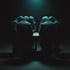 Silhouettes of people gathered around a dim table