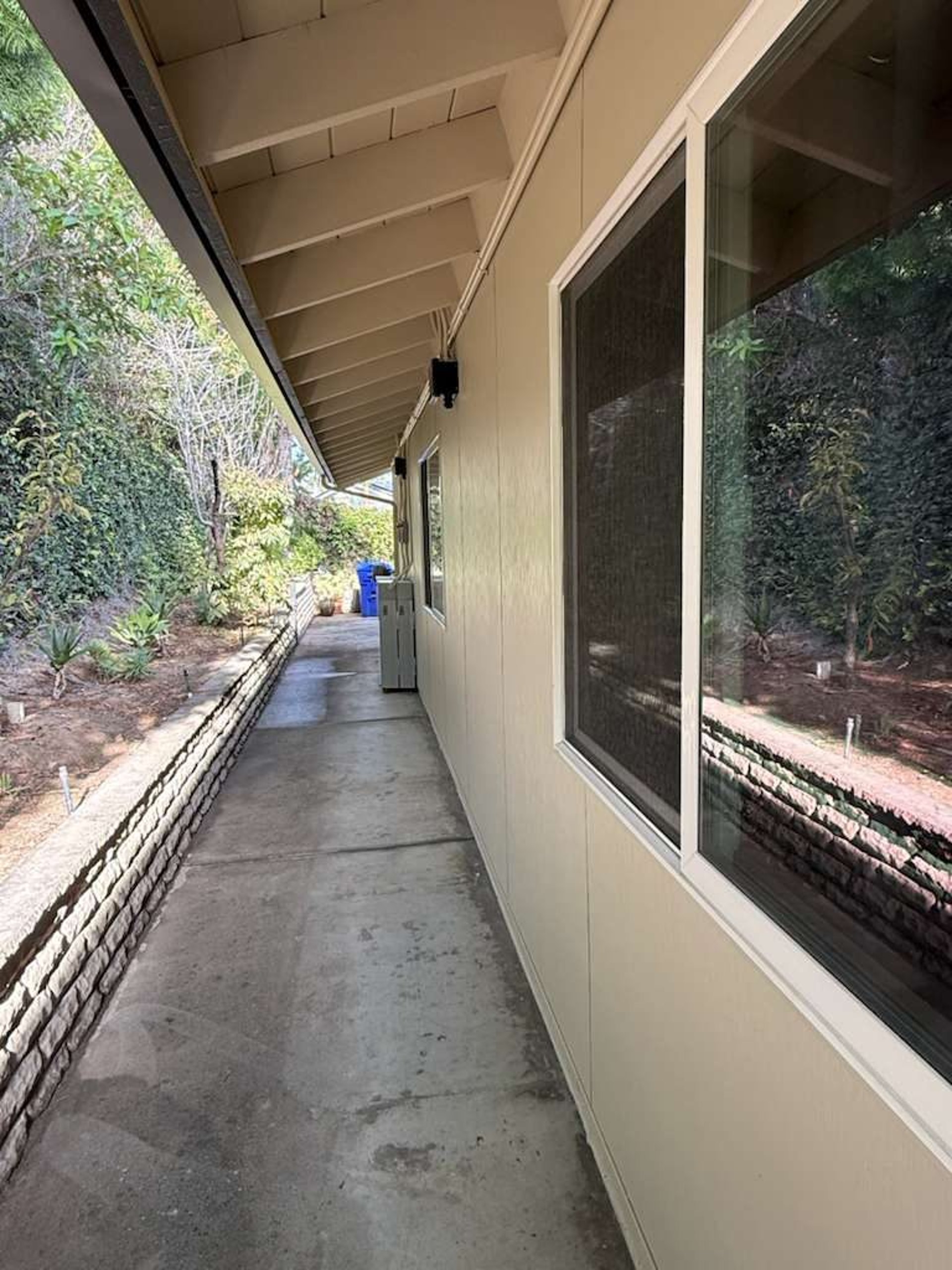 Covered walkway beside James Hardie Architectural Panel siding on a San Diego home