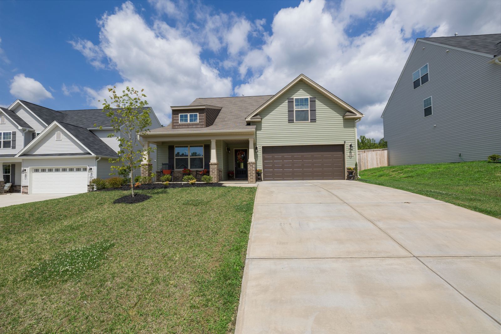 Detached suburban home with a pitched asphalt shingle roof