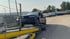 Vier Autotransporter der Hess Fahrzeuglogistik mit geladenen Fahrzeugen auf einem Parkplatz.