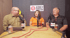 Two men, one bald with glasses, one with dark hair, sit at a table with microphones, "Ask the Surveyor" logo behind them.