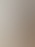 Wand in cremigem Beige, ruhig gehalten neben freistehender Wanne und LED-Lichtlinie.