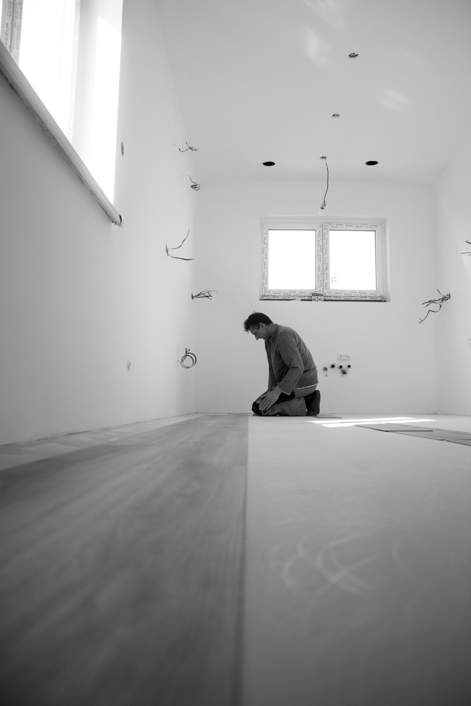 Bare plywood subfloor being prepared before new flooring goes down