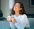 Happy and relaxed woman holding a mug.