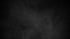 Dark gray, textured background with subtle, light gray smoky effects