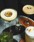 Vier Cocktails auf dem Tisch: Passionsfrucht-Martini, Espresso Martini, grüner Cocktail, cremiger Cocktail, mit „GUTS & GLORY“