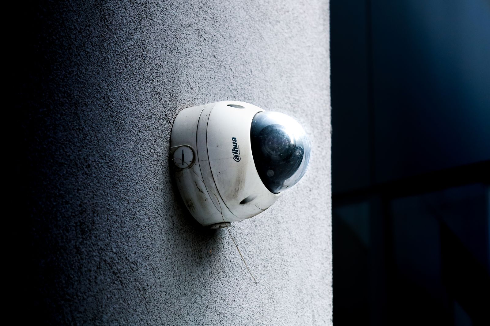 Dome security camera mounted on the corner of a house