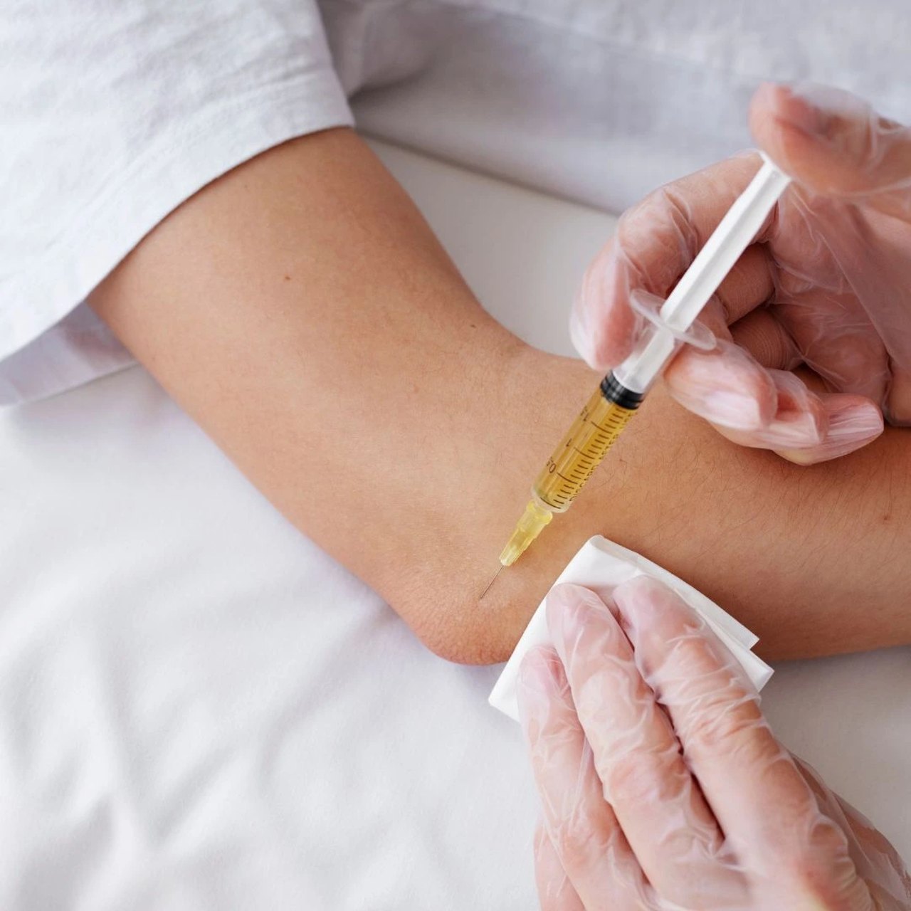 Closeup of a clinician giving an arm injection