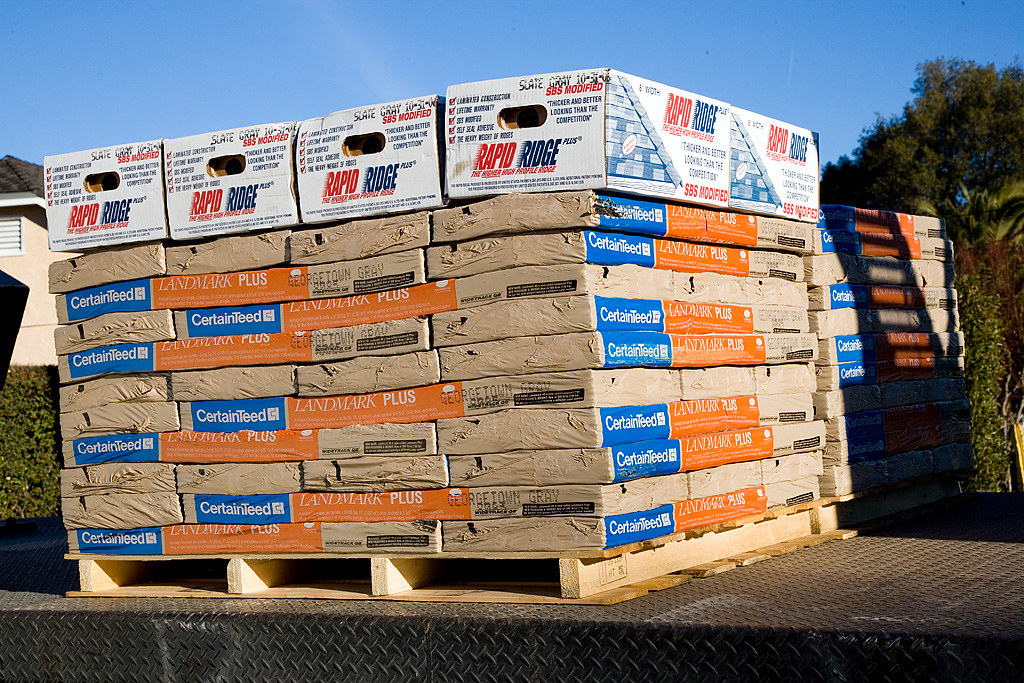 Pallets of roofing shingles stacked ready for a Carrollton job