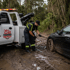Towing Deltona winch out and recovery service pulling a car from deep mud using professional recovery equipment