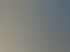 Ein Miele-Sonnenschutz über einem Ladeneingang, befestigt an einer beigen Gebäudewand.