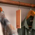 Cedar plank inside a premium wardrobe beside folded wool sweaters and a tailored jacket