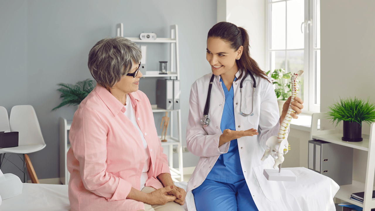 A provider talking with a patient in a bright consultation room