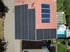 Dach mit vielen schwarzen Solarmodulen, drei Solarthermie-Kollektoren und einem Pool.