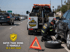 Towing Eastvale flat tire change service safely replacing a flat tire on a busy roadside with proper safety equipment and traffic control
