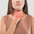 Woman touching her neck, with an illuminated thyroid gland superimposed on her throat