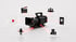 Schwarze Filmkamera umgeben von Icons für Video, Audio, Social Media und Produktion, verbunden durch rote Laserlinien.
