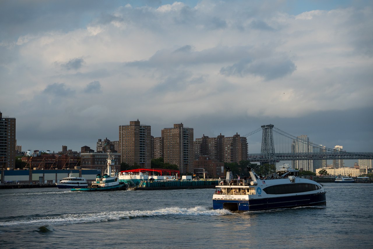 Ferry crossing the East River with the Williamsburg Bridge behind, New York