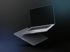 Zwei schwebende, offene graue Laptops mit schwarzem Bildschirm auf dunklem Hintergrund.