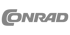 Graues Conrad-Logo auf dunklem Hintergrund.