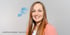 Christina Pulsinger, Head of HR, lächelt mit langen rötlich-braunen Haaren und einem pfirsichfarbenen Blazer.
