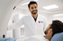 Radiologist standing beside a patient at an MRI scanner, illustrating diagnostic imaging, radiology, and early disease detection.