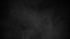 Dark gray, textured background with subtle, light gray smoky effects