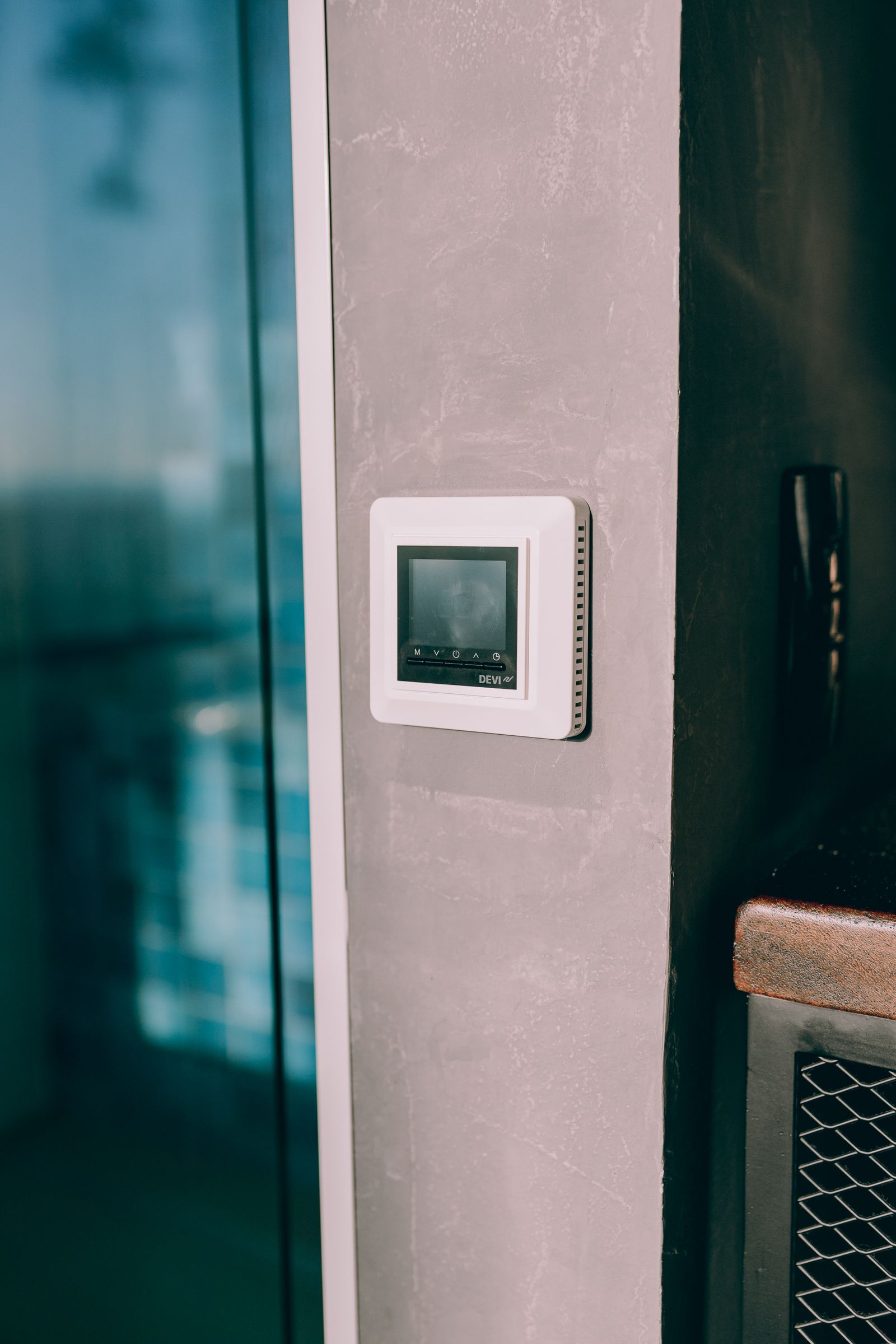 A wall-mounted smart home control beside a window