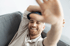 Man smiling and showing hand gesture in a wellness clinic setting