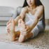 A woman stretching to get rid of plantar fasciitis.