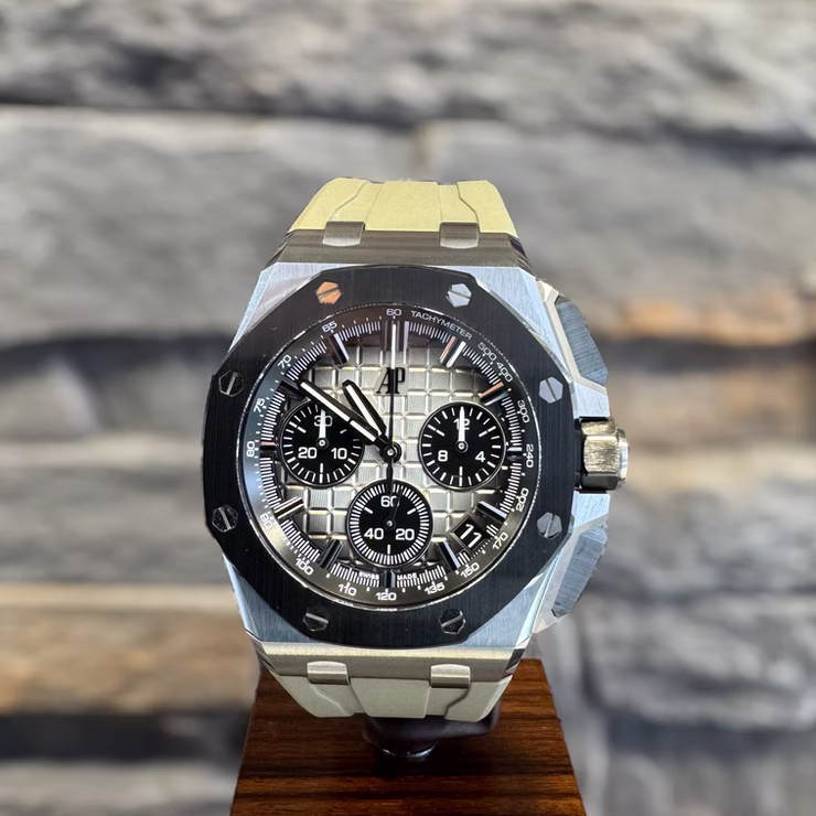 Luxuriöse Audemars Piguet Armbanduhr mit weißem Zifferblatt, drei schwarzen Chronographen und weißem Kautschukarmband.