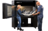 Zwei Personen entnehmen ein großes, komplexes 3D-gedrucktes Teil aus einem Stratasys F770 3D-Drucker.