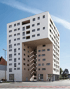 Modernes, hohes Gebäude mit weißer und beiger Fassade, Aussparung in der Mitte, an einer Straße.