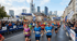 Läufer überqueren die Ziellinie mit bedruckten Laufshirts bei einem Marathon.